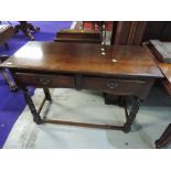 A modern period style oak side table having two frieze drawers and baluster supports