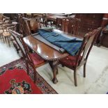 An early/mid 20th century mahogany dining suite in the Chippendale revival style comprising wind out