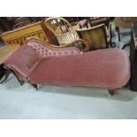 A 19th century mahogany frame chaise longue of roll end, scroll design having 20th century pink