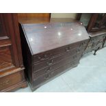 An early 19th century mahogany bureau having slope front and fitted interior including 'book'