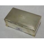 A silver cigarette box having engine turned decoration, plain cartouche and bracket feet, Birmingham