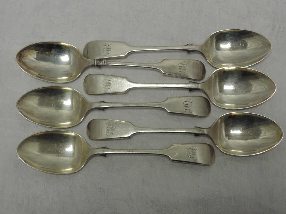 A set of six Edwardian silver dessert spoons of fiddle back form bearing monogram to terminals,