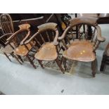 A set of three late 19th/early 20th century beech and elm smokers bow armchairs having spindle