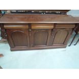 A modern Victorian style part mahogany sideboard base having three pulvinated frieze drawers and