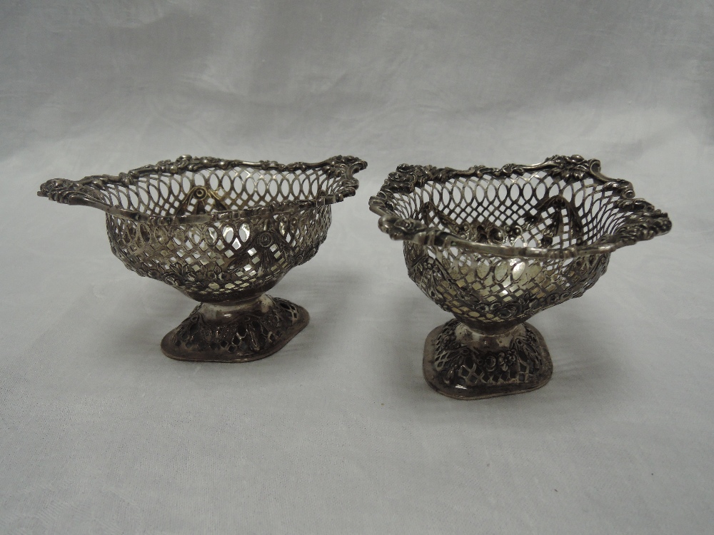 A pair of Victorian silver bon bon dishes having pierced and moulded decoration on pedestal feet,