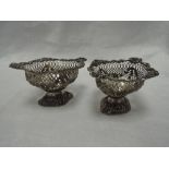 A pair of Victorian silver bon bon dishes having pierced and moulded decoration on pedestal feet,
