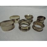 Six HM silver napkin rings of various forms including two pairs