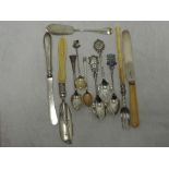 A selection of HM silver flatware including souvenir spoons, butter knives and pickle fork etc