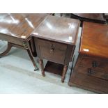 A 19th century part mahogany nightstand having drop flap top on frieze drawer and pot cupboard on