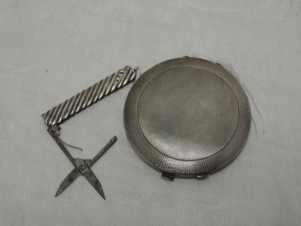 A silver powder compact having engine turned decoration, Birmingham 1940, Charles Green & Co Ltd,