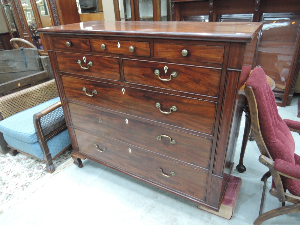 An early 19th century mahogany chest of three frieze, two short and three long drawers, on shaped