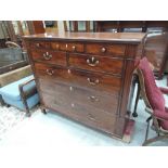 An early 19th century mahogany chest of three frieze, two short and three long drawers, on shaped