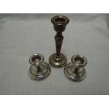 A pair of silver candle sticks of squat form, Birmingham 1976, W I Broadway, and a single silver