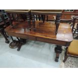 An early Victorian rosewood side table having frieze drawers and having column supports with