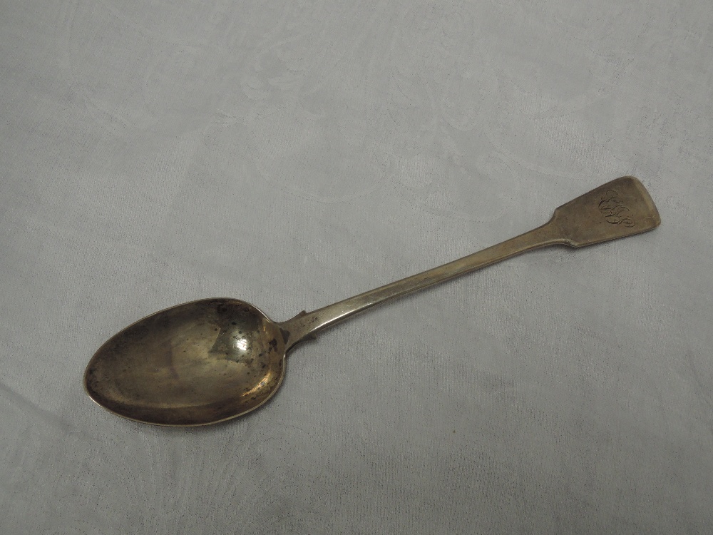 A Georgian silver basting spoon of fiddle back form bearing monogram to terminal, London 1825,