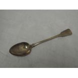 A Georgian silver basting spoon of fiddle back form bearing monogram to terminal, London 1825,