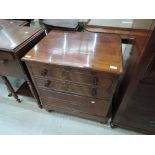 A 19th century mahogany commode formed as small chest of drawers, with lift top and fitted interior,