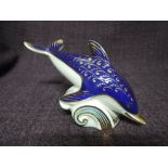A Royal Crown Derby paperweight. Dolphin modelled by Robert Jefferson decorated and design by