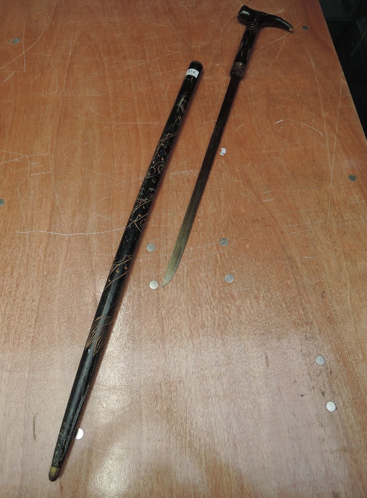 An early 20th century ebonized sword stick having coiled dragon decoration with carved face on