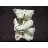 A Royal Crown Derby paperweight. Bear Hug modelled by Mark Delf with decoration design by Louise