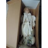A Sigikid limited edition doll by Maja Bill Buchwalder wearing cream hat and coat with