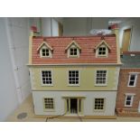 A modern three storey dolls house of traditional design