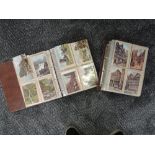 Two modern postcard albums containing approximately three hundred plus artist vintage postcards,