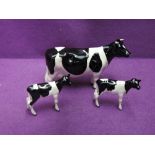 Three Beswick studies, Friesian Cow 1362A and two Friesian Calves 1249C (one restored)