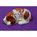 A Royal Crown Derby paperweight. Puppy modelled by Mark Delf and decoration design by Louise