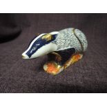 A Royal Crown Derby paperweight. Woodland Badger modelled by Donald Brindley decoration design by