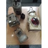 Four railway oil/paraffin lamps, one having red Bullseye lens, one BR (M), and two Lamp