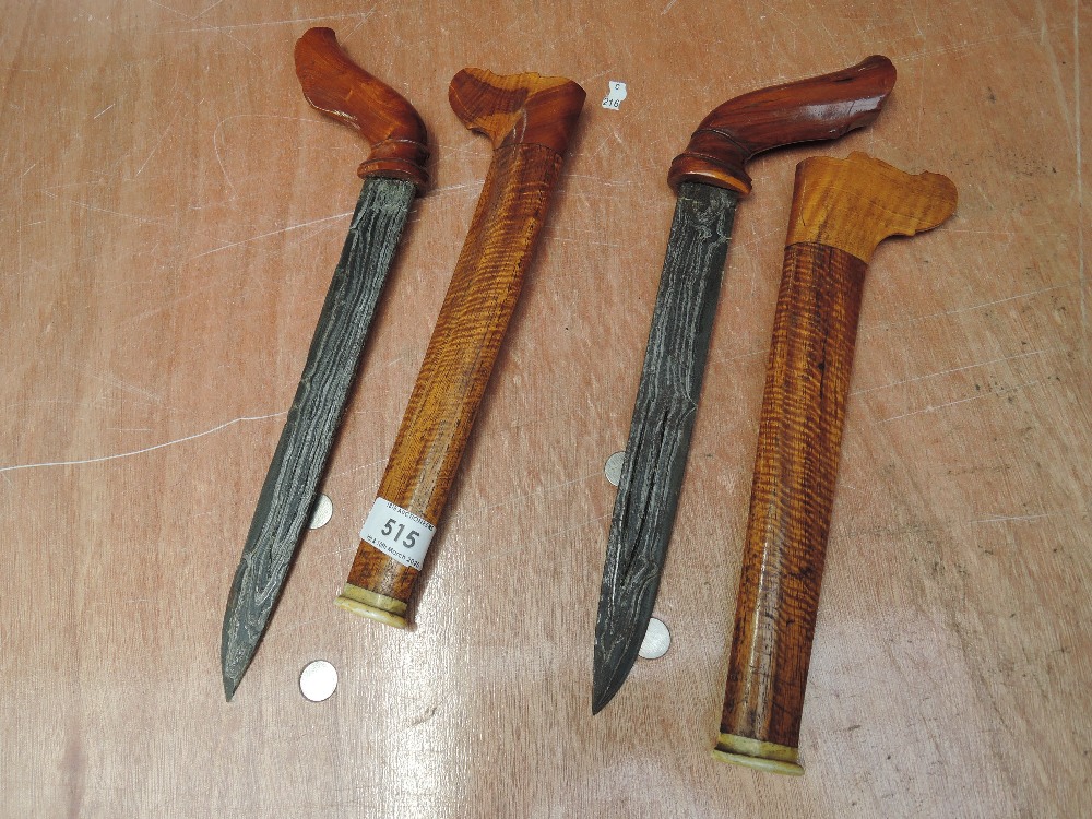 A pair of late 19th or 20th century Indonesian/straight settlements Kris Daggers having wood handles