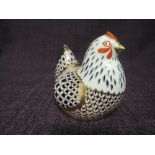 A Royal Crown Derby paperweight. Chicken modelled by Robert Jefferson and decoration design by Jo