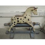 A traditional painted wooden Rocking Horse having horse (af) on pine swing action base having name