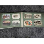 A vintage postcard album containing approximately two hundred vintage military postcards