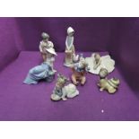 Seven Nao figurines including girls, boys and young children