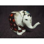 A Royal Crown Derby paperweight. Small Elephant modelled by Tabbenor and decoration design by Jo