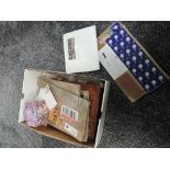 A box of World Stamps in albums and loose along with Cigarette Cards
