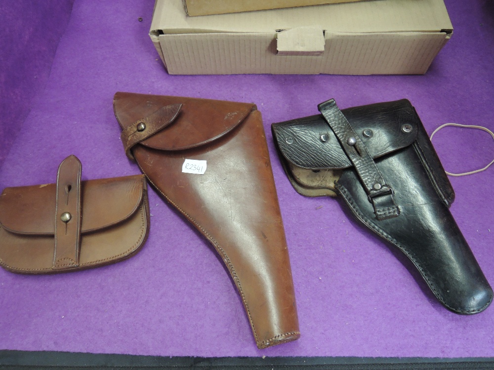 A black leather German WW2 Luga Pistol Holder in good condition along with a British WW2 brown