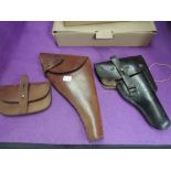 A black leather German WW2 Luga Pistol Holder in good condition along with a British WW2 brown