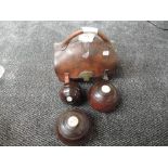 A pair of treen Bowling Bowls and a treen Jack bearing initials SM in a traditional leather carry