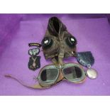 A vintage RAF leather flying helmet with goggles, a vintage compass and cloth badges