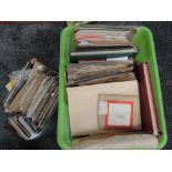 A collection of World Stamps in albums and loose along with a selection of mixed vintage Postcards