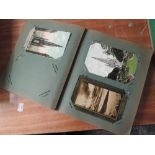A vintage Postcard album containing good real photo cards