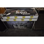 A Nintendo Wii Beatles Rockband game and two guitar controllers