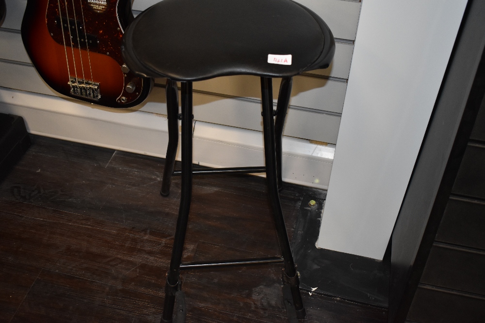 A padded guitar stool/stand