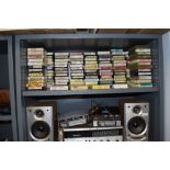 A large collection of vintage 8 track cassettes, players and a Sharp recorder