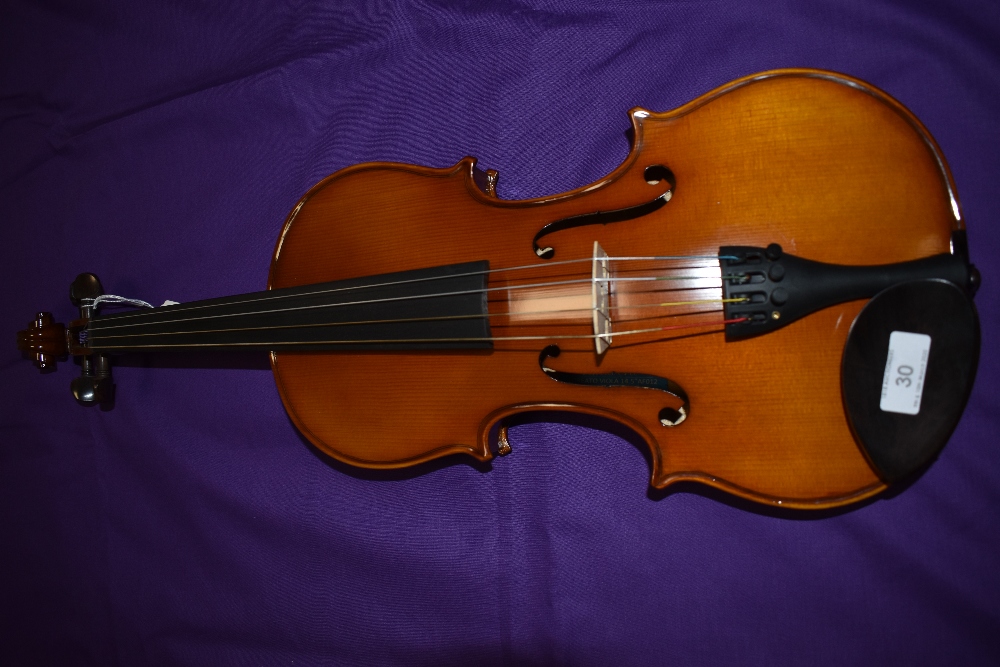 A traditional violin, labelled Primavirera