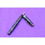 A Parker Duofold, in black and pearl straited with single broad and two narrow bands to cap,