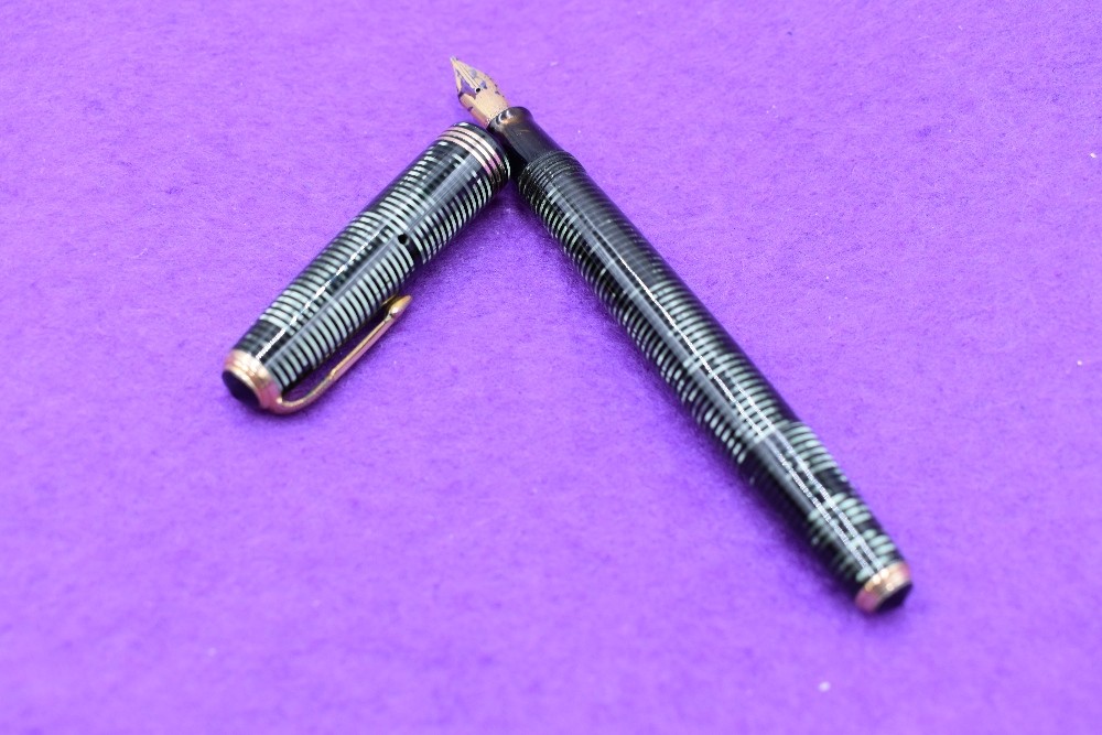 A Parker Vacumatic in black and green with three narrow bands to cap